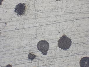 Optical image of nodular cast iron after the fine grinding step. Optical image of nodular cast iron after the fine grinding step.